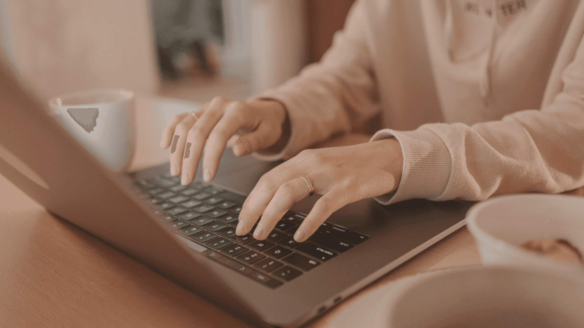 Closeup hands of woman while working, using laptop computer