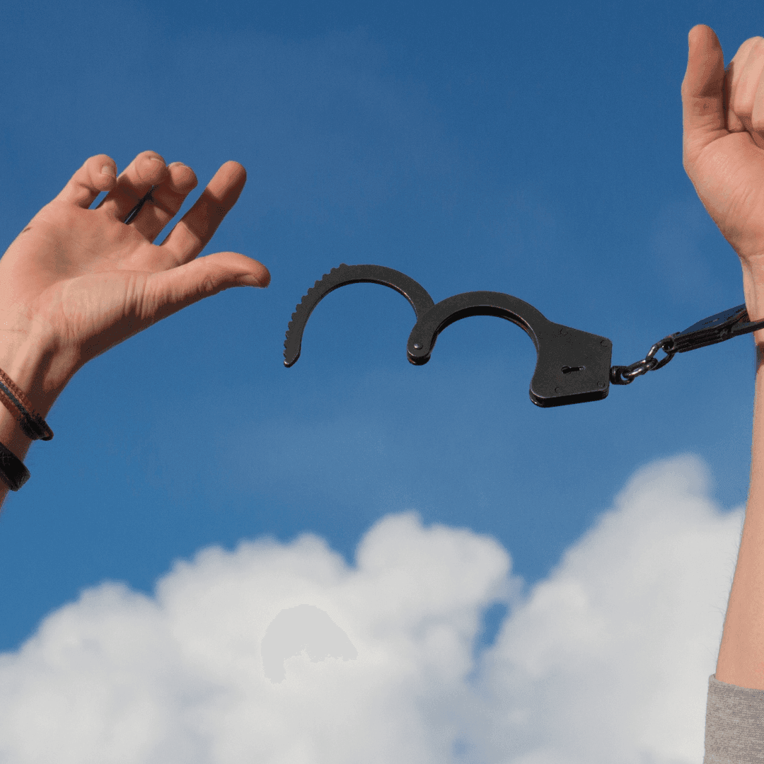 blue sky with hands free from handcuffs