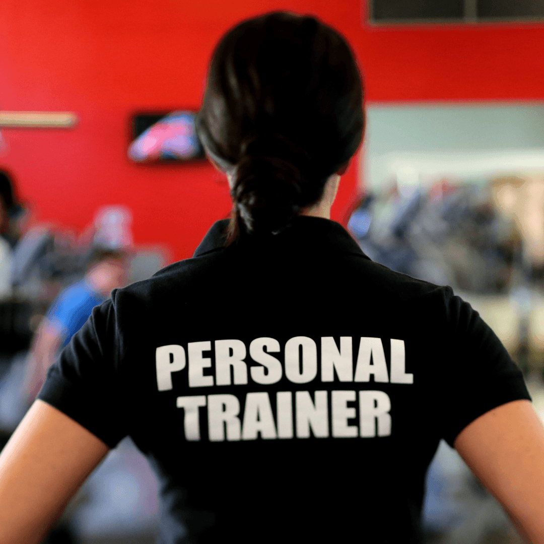 Woman with a black t-shirt that says personal trainer on the back